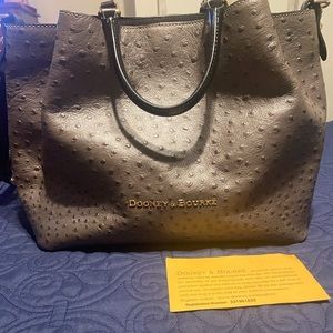 Dooney & Bourke gray ostrich-inspired leather handbag with red interior.